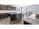 Open kitchen with dark wood cabinetry, granite countertops, and stainless steel appliances at 112 Gadsbury Dr, Holly Springs, NC 27540