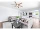 Spacious living room with hardwood floors, ceiling fan, neutral paint, and comfortable seating at 112 Gadsbury Dr, Holly Springs, NC 27540