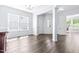 Spacious living area with hardwood flooring, white trim and pillars leading to other rooms at 112 Gadsbury Dr, Holly Springs, NC 27540