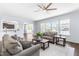 Open floor plan living room with large windows and comfortable seating area at 112 Gadsbury Dr, Holly Springs, NC 27540