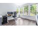 Bright office area with three windows offering lots of natural light, and hardwood flooring at 112 Gadsbury Dr, Holly Springs, NC 27540
