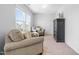 Sitting room with two chairs, natural light, and neutral colors at 112 Gadsbury Dr, Holly Springs, NC 27540