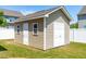Well-kept storage shed with white doors in a spacious back yard at 112 Gadsbury Dr, Holly Springs, NC 27540