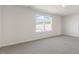 Bedroom featuring wall-to-wall carpet, neutral paint, and a large window at 112 Global Ave, Fuquay Varina, NC 27526