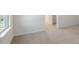 Bedroom with wall-to-wall carpet, neutral paint, and a large window at 112 Global Ave, Fuquay Varina, NC 27526