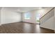 Bright living room featuring wood floors, a staircase, a window, and access to the outdoor space at 112 Global Ave, Fuquay Varina, NC 27526