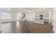 Open floor plan with wood floors connecting the living area to the kitchen and staircase at 112 Global Ave, Fuquay Varina, NC 27526