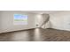 Bright living room featuring hardwood floors, a staircase, and a door leading to the outside at 112 Global Ave, Fuquay Varina, NC 27526