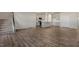 Spacious living area with hardwood floors, an open layout, a staircase, and a view of the kitchen at 112 Global Ave, Fuquay Varina, NC 27526