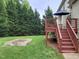 Backyard featuring a wooden deck with stairs leading down to the custom-built garden plot at 113 Chesterfield Dr, Cary, NC 27513