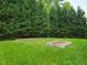 Spacious backyard featuring lush green grass and a custom-built garden plot at 113 Chesterfield Dr, Cary, NC 27513