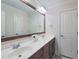 Bathroom vanity with double sinks, a large mirror, and dark wood cabinets at 113 Chesterfield Dr, Cary, NC 27513