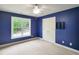 Blue bedroom featuring a window letting in natural light and a double door closet at 113 Chesterfield Dr, Cary, NC 27513