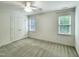 Bright bedroom with carpeted floors, two windows, and a double door closet at 113 Chesterfield Dr, Cary, NC 27513