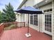 Outdoor wooden deck features a dark navy umbrella, and views of the surrounding foliage at 113 Chesterfield Dr, Cary, NC 27513