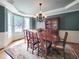 Formal dining room featuring elegant wainscoting, a chandelier, and large windows with natural light at 113 Chesterfield Dr, Cary, NC 27513