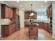 Spacious kitchen with wood cabinets, stainless appliances, and granite countertops centered around a functional island at 113 Chesterfield Dr, Cary, NC 27513