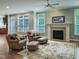 Comfortable living room with a fireplace, plush seating, and large windows, creating a cozy ambiance at 113 Chesterfield Dr, Cary, NC 27513