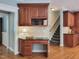 Cozy office nook featuring wooden cabinetry with granite countertops and a staircase leading to the second floor at 113 Chesterfield Dr, Cary, NC 27513