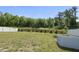 Wide backyard with a white fence, lawn, and lake beyond at 115 Zulabelle Ct, Garner, NC 27529
