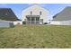 Open backyard featuring a white fence, screened porch, and well-maintained lawn at 115 Zulabelle Ct, Garner, NC 27529
