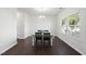 Well-lit dining room showcasing dark hardwood floors and a modern chandelier at 115 Zulabelle Ct, Garner, NC 27529