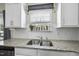 Kitchen sink and granite countertops with a window and decorative plants at 115 Zulabelle Ct, Garner, NC 27529