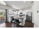 Modern kitchen featuring white cabinets, stainless steel appliances, and a center island at 115 Zulabelle Ct, Garner, NC 27529