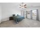 Spacious main bedroom featuring plush carpet, a ceiling fan, and bright natural light from two large windows at 115 Zulabelle Ct, Garner, NC 27529