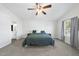 Comfortable main bedroom with plush carpet, ceiling fan, and an en-suite bathroom for added convenience at 115 Zulabelle Ct, Garner, NC 27529