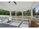 Comfortable screened porch with a ceiling fan, a tranquil outdoor view, and inviting seating arrangements at 115 Zulabelle Ct, Garner, NC 27529
