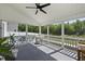 Inviting screened porch features a ceiling fan, comfortable seating, and a serene outdoor view at 115 Zulabelle Ct, Garner, NC 27529