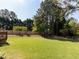 Spacious backyard features a well-maintained lawn, mature trees, and privacy fencing at 117 Whitehaven Ln, Cary, NC 27519