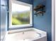 Bathroom featuring a soaking tub with a window at 117 Whitehaven Ln, Cary, NC 27519