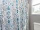 Comfortable bathroom features a decorative shower curtain and natural lighting at 117 Whitehaven Ln, Cary, NC 27519