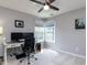 Bright bedroom with a ceiling fan, a desk with monitors, and natural light at 117 Whitehaven Ln, Cary, NC 27519