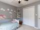 Charming bedroom featuring a closet, ceiling fan, and dinosaur-themed decorations at 117 Whitehaven Ln, Cary, NC 27519