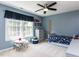 Bright bedroom with large window, ceiling fan, and space-themed decor at 117 Whitehaven Ln, Cary, NC 27519