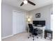 Comfortable bedroom with a large closet, desk with monitors, and a ceiling fan at 117 Whitehaven Ln, Cary, NC 27519