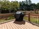 Covered grill on wooden deck, ideal for outdoor cooking and entertaining in the backyard at 117 Whitehaven Ln, Cary, NC 27519