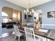 Dining room with arched doorway, seamlessly connected to the living room and kitchen at 117 Whitehaven Ln, Cary, NC 27519