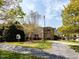 Community entrance with stone facade, mature trees, and well-manicured landscaping at 117 Whitehaven Ln, Cary, NC 27519
