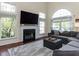 Bright living room with fireplace, large windows, and a comfortable sectional sofa at 117 Whitehaven Ln, Cary, NC 27519