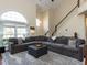 Spacious living room featuring a large sectional sofa, high ceilings, and a grand arched window at 117 Whitehaven Ln, Cary, NC 27519