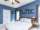 Brightly lit main bedroom with blue walls and rustic decor at 117 Whitehaven Ln, Cary, NC 27519