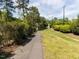 Scenic community pond with fountain, walking path, and lush greenery at 117 Whitehaven Ln, Cary, NC 27519