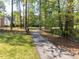Picturesque walking path along a serene pond surrounded by mature trees at 117 Whitehaven Ln, Cary, NC 27519