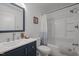 Bright bathroom with a modern vanity, tiled shower, and updated fixtures at 120 King Charles Rd, Hillsborough, NC 27278