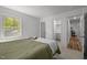 Bright bedroom featuring a closet and doorway to the bathroom, flooded with natural light at 120 King Charles Rd, Hillsborough, NC 27278