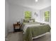 Comfortable bedroom with an olive green comforter and bright windows showcasing the outdoor view at 120 King Charles Rd, Hillsborough, NC 27278